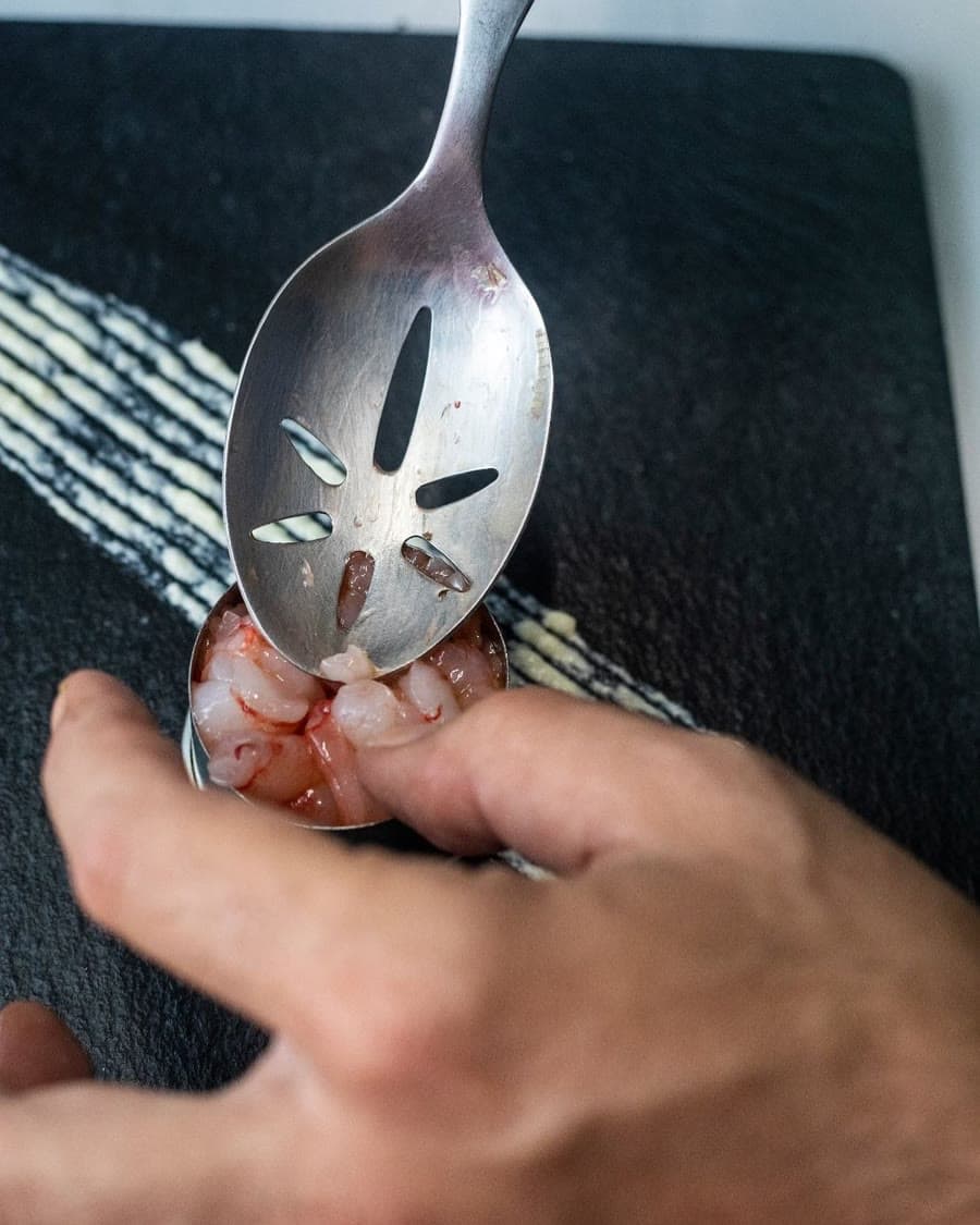 Hand-plating tiger prawn into the ring mould